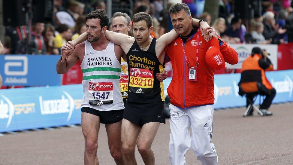 Matthew Rees helps David Wyeth over the finish line.