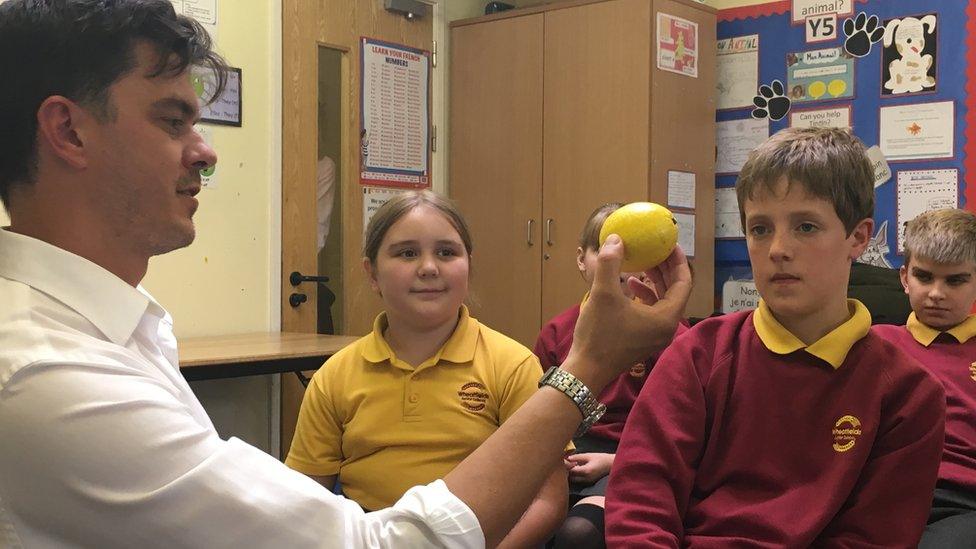 Dr Geach shows pupil a lemon