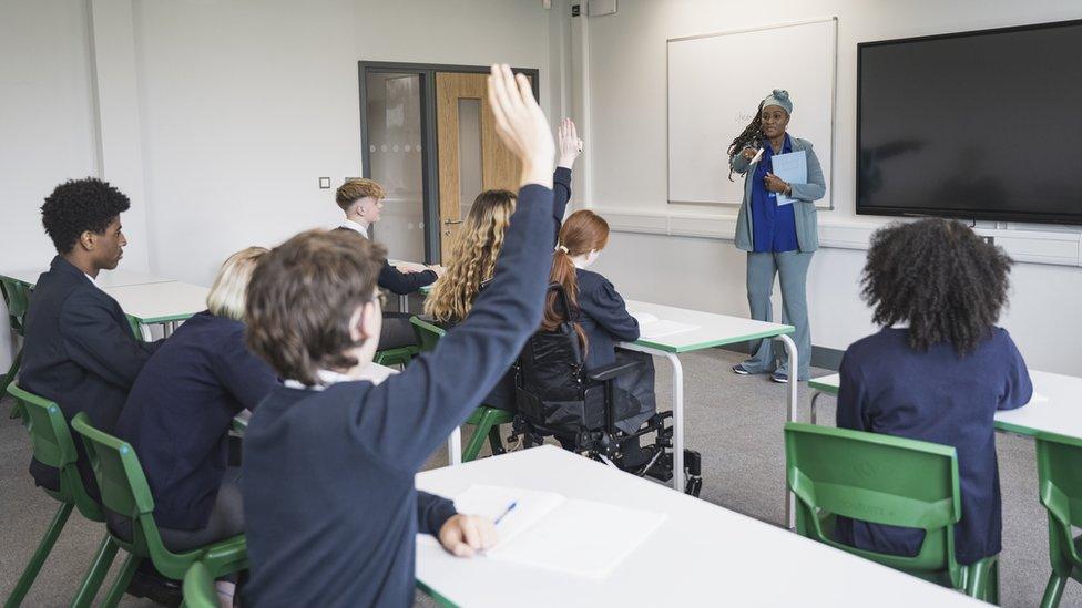 Children in school uniform in class