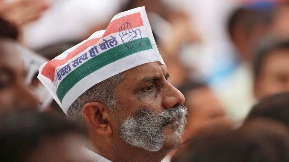 A supporter of India"s main opposition Congress party listens a speech by the party"s president Sonia Gandhi (unseen) before what the party calls as "Save Democracy" march to parliament in New Delhi, India, May 6, 2016