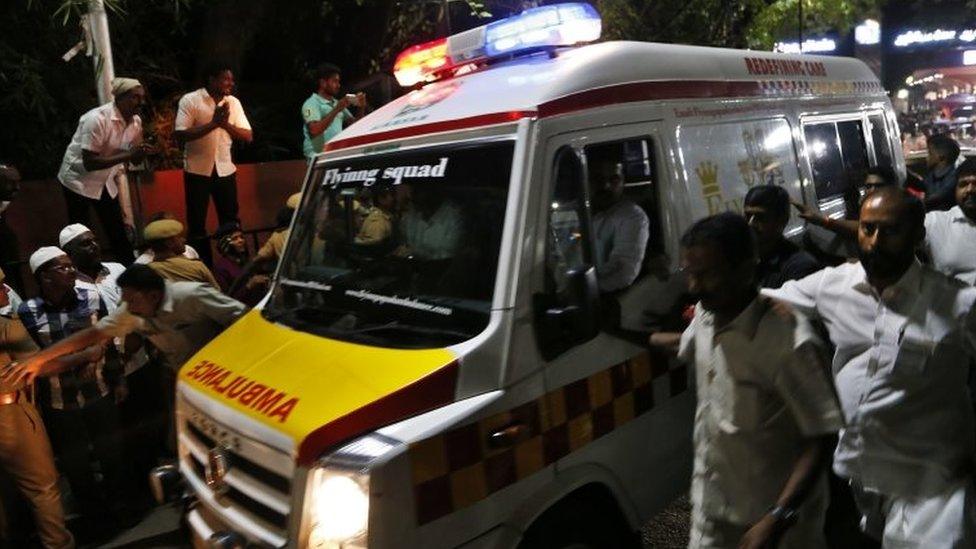 Jayalalitha's supporters run beside an ambulance carrying her body in Chennai. Photo: 6 December 2016