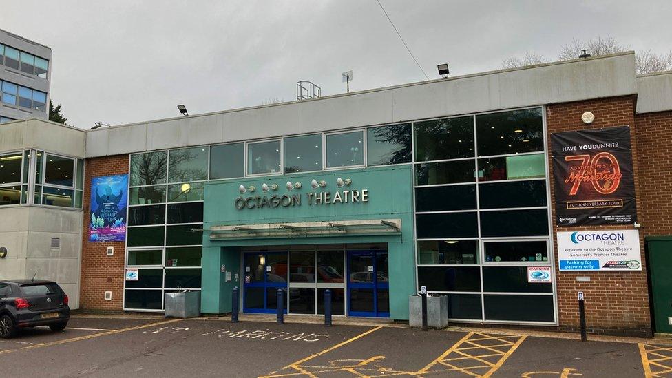 Image of Octagon Theatre exterior. The sign is mint green and the venue name is spelled out in silver capital letters above the entrance.