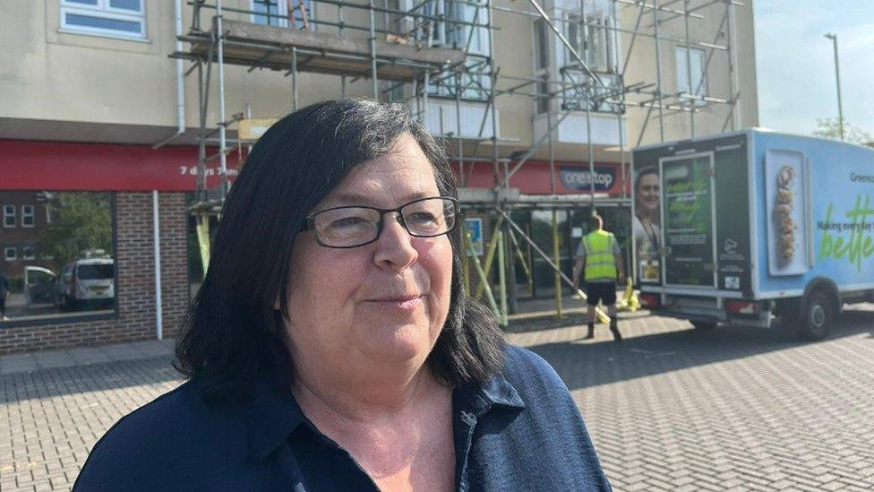 Diane outside One Stop shop at Sandell Place, Amesbury