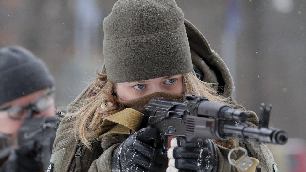 A woman attends military training for reservists