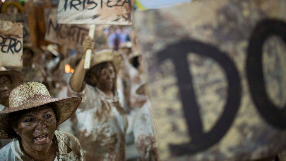 Rio carnival performers portrayed victims of the mud slide, holding up signs reading 'Death' and 'Sadness'