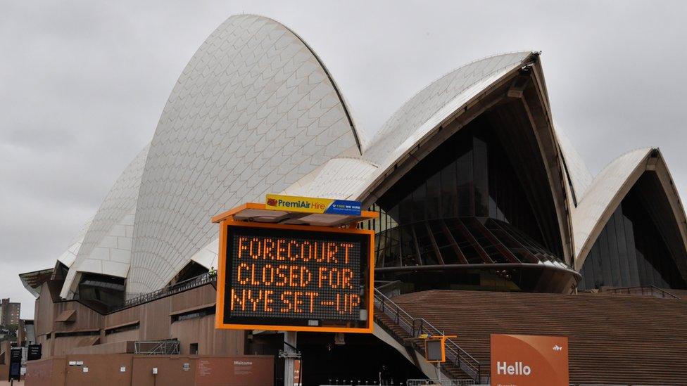 A sign which reads 'Forecourt closed ahead of NYE set-up' in front of the Sydney Opera House