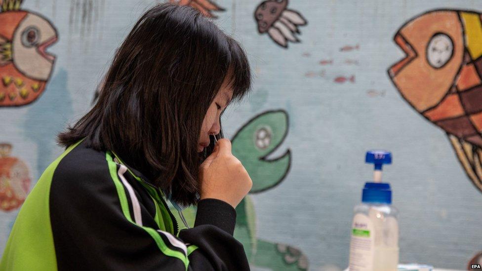 girl in hong kong taking a coronavirus test
