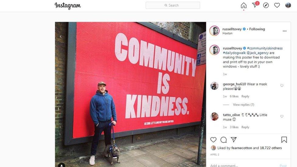 Man in front of a billboard poster