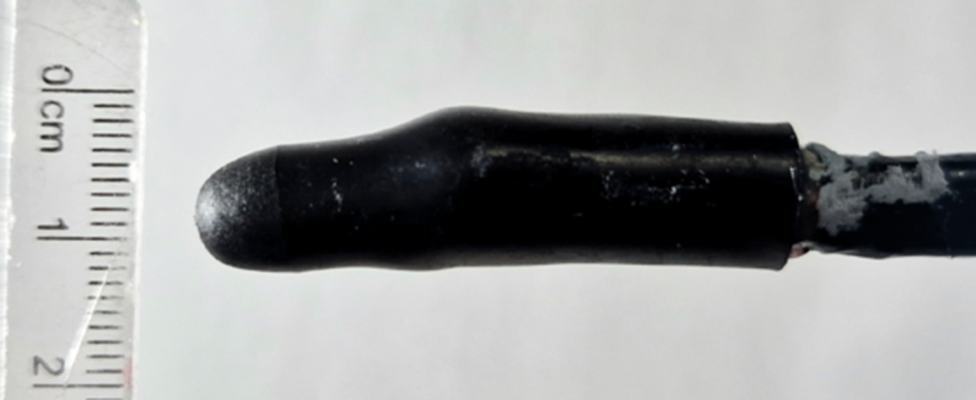 The end of a small black sensor with a ruler alongside it, showing it to be 10mm across. It is on a white background