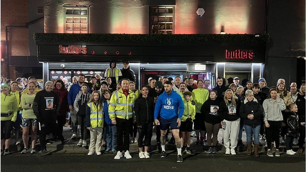 Runners in hi-viz jackets gather for a run