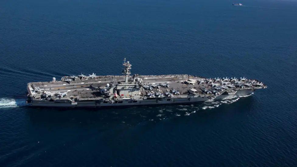 The USS Abraham Lincoln - a large aircraft carrier - pictured at sea