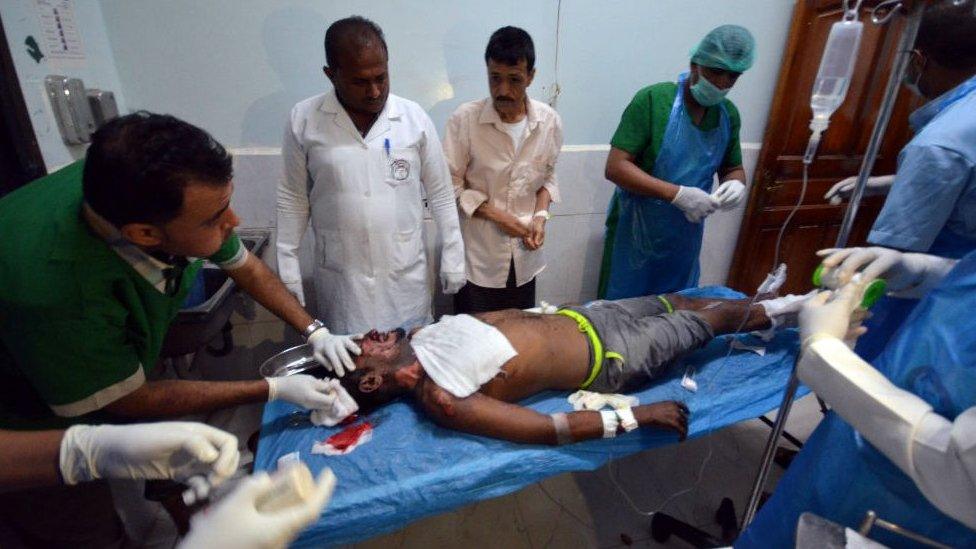 Medics attend to man injured by Saudi-led air strikes on a prison near the Red Sea port of Hudaydah, Yemen, October 30, 2016