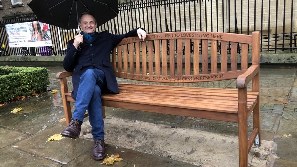 Mark Radcliffe on a bench that bears his name