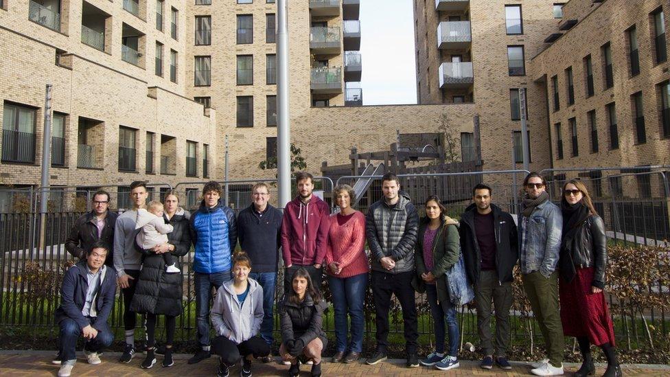 Residents in front of their building