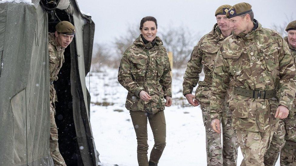 The Princess of Wales seen in camouflage gear with members of the Irish Guards during a visit to the Salisbury Plain Training Area in Wiltshire