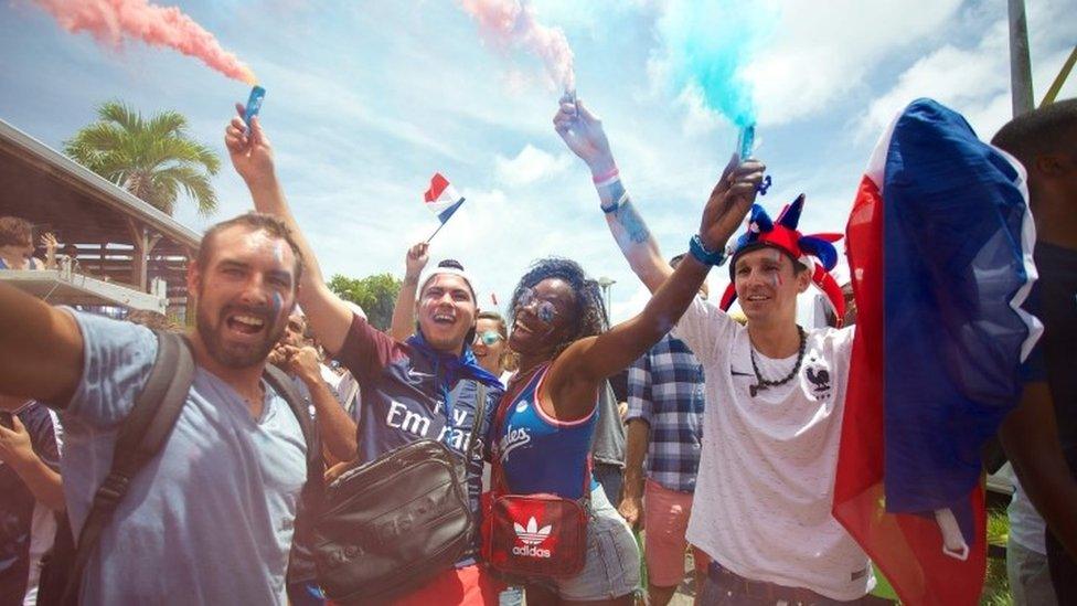 People celebrate after France won the Russia 2018 World Cup final football match against Croatia, on 15 July 2018 in Le Gosier on the French overseas Caribbean island of Guadeloupe