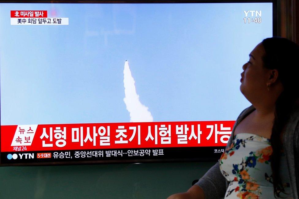 A South Korean woman watches a televised news broadcast at Seoul Station, in Seoul, South Korea, 5 April 2017