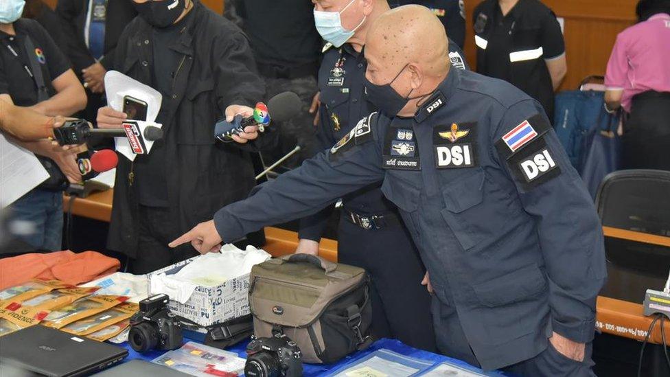 Thai police display items at a press conference