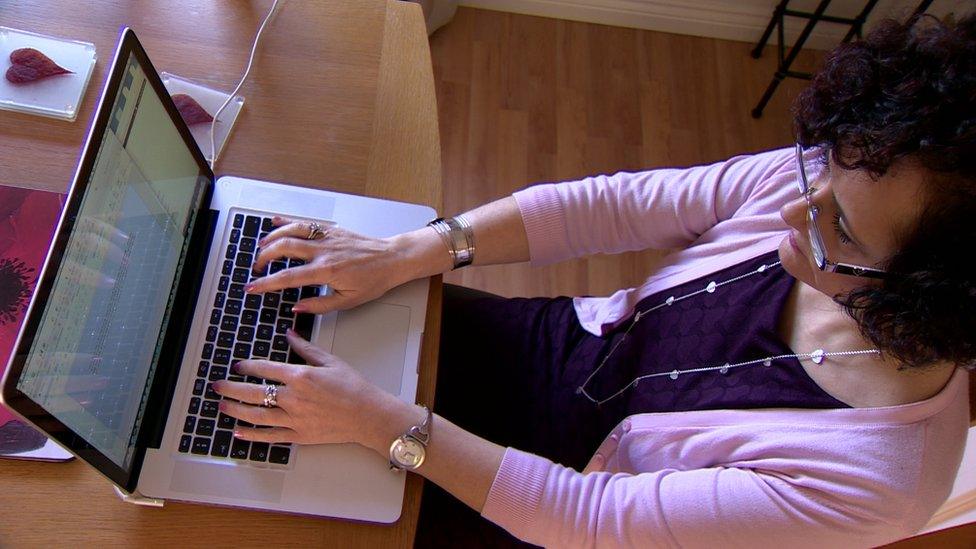 Dr Eunice Minford typing on her computer