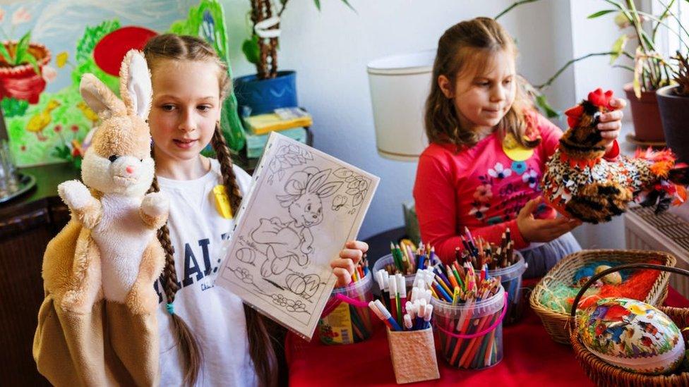 Antonia Marksevka (L) from Ternopil and Avigeja Radionow (L) from Sloviansk, who fled war-torn Ukraine, during Easter preparations held for Ukrainian refugee children at the Slawia cultural center on April 12, 2022 in Halle, Germany. Slawia Kulturcentrum is a local initiative launched in 2001 to assist Slavic immigrants and is including refugees from Ukraine in its projects. Over 300,000 Ukrainians, the vast majority of them women and children, have registered in Germany after fleeing their homeland due to the ongoing Russian military invasion.