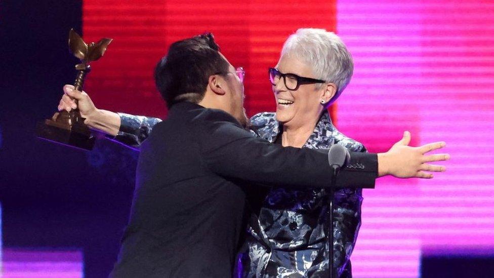 Director Daniel Kwan embraces Jamie Lee Curtis