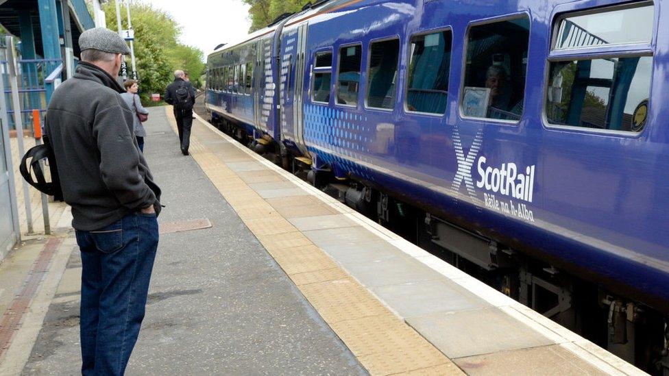 passengers waiting to board train