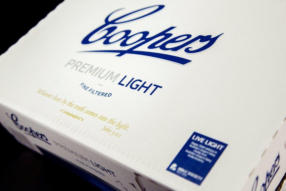 A carton of Coopers premium light beer with a Bible verse printed on it