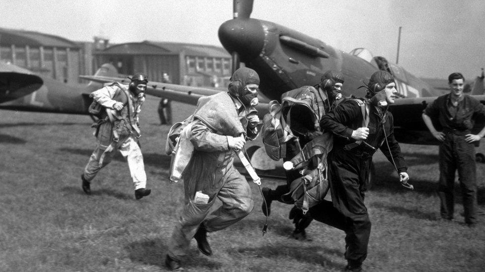 A squadron of Spitfires took part in mimic 'air alarms', during a speed demonstration at Duxford Aerodrome, 4th May 1939. Seen here are some of the pilots rushing to their planes before take off.