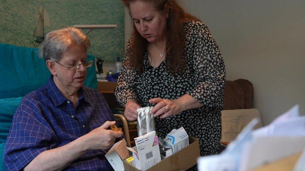 Adam and Tertia Eisenberg sorting through a box of medicines