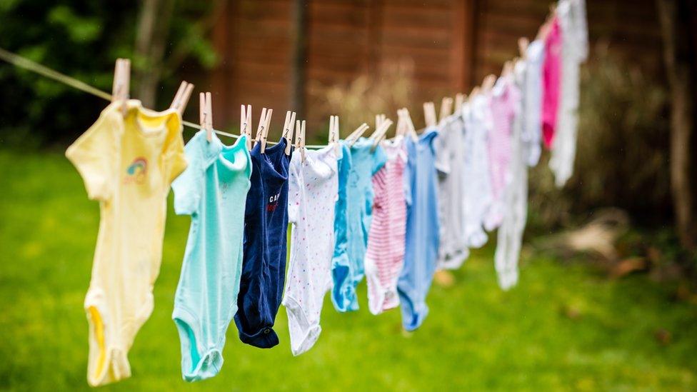 A washing line pegged with 15 baby-grows