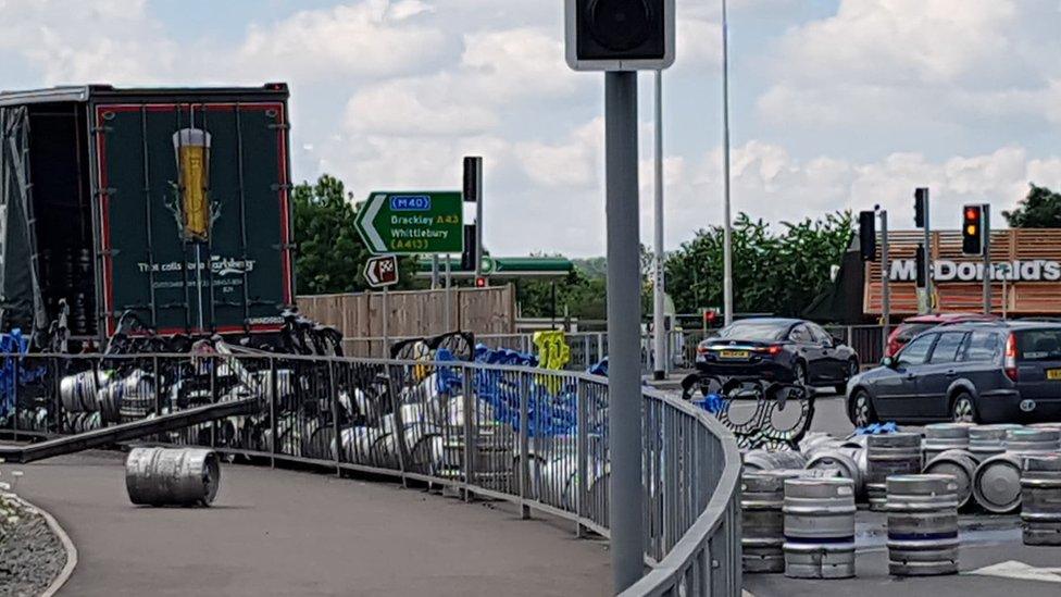 Beer kegs on the road, having falling from a lorry on the A43 near Towcester.