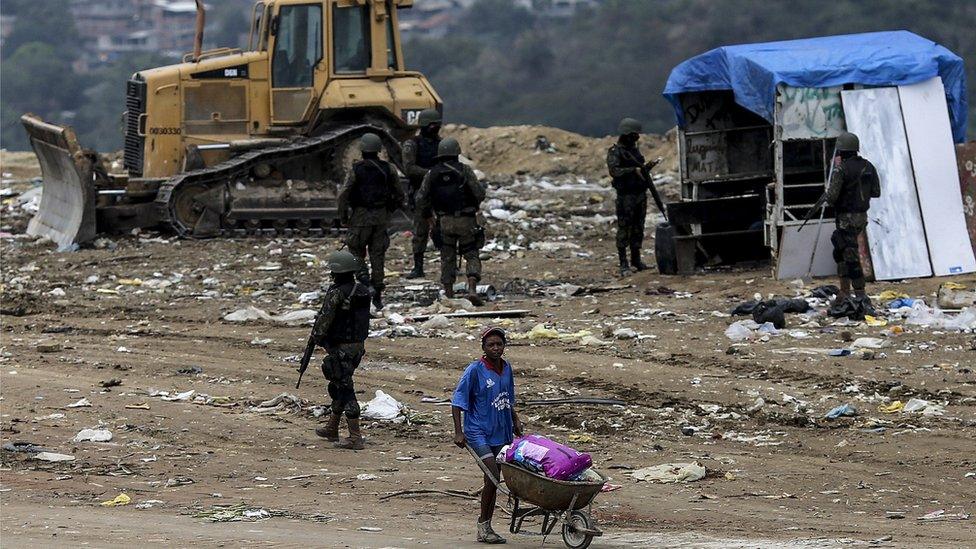 Law enforcement officers search an area in Niteroi, in the metropolitan region of Rio de Janeiro, Brazil, 16 August 2017