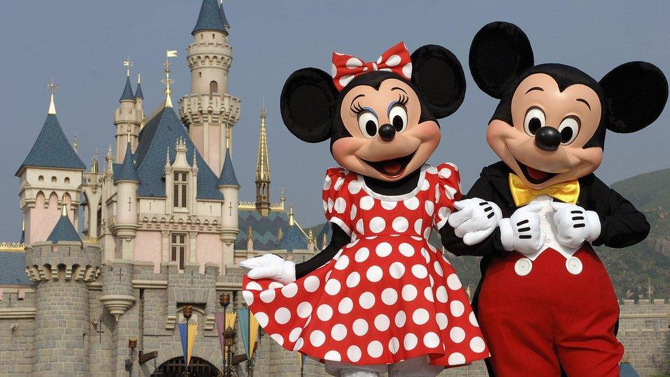 Mickey Mouse and Minnie Mouse in front of the magical castle in Disney World