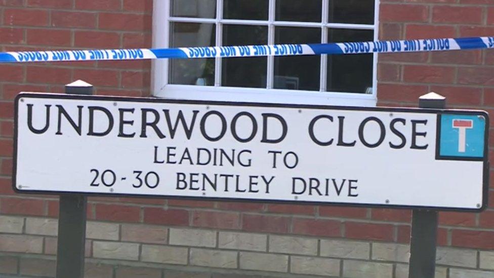 Police cordon above street sign