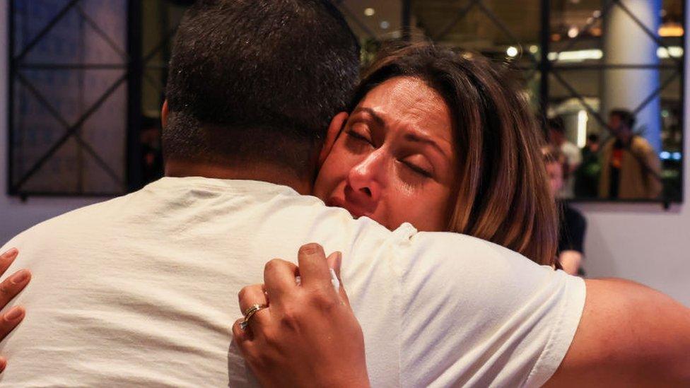 Two people hug at a Yes campaign event