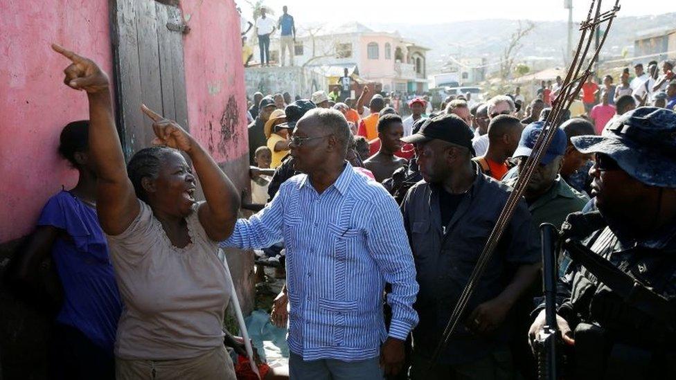 A woman reacts as Haiti"s Interim President Jocelerme Privert (C) visits after Hurricane Matthew passes in Jeremie, Haiti, October 8, 2016