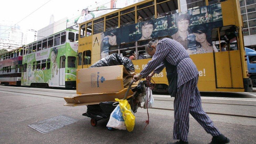 An elderly woman collecting rubbish