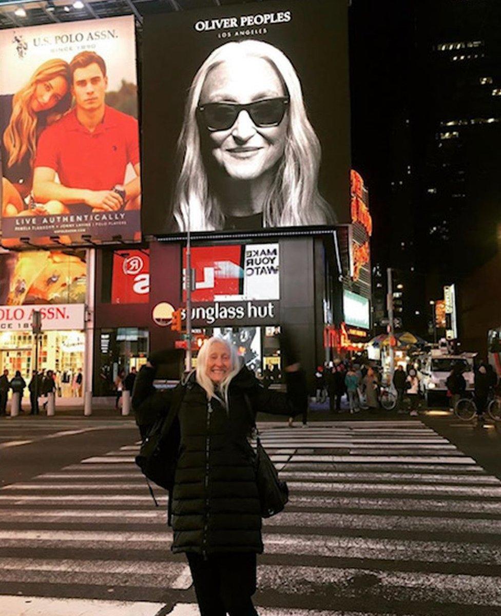 Gillean in Times Square with her billboard in the background