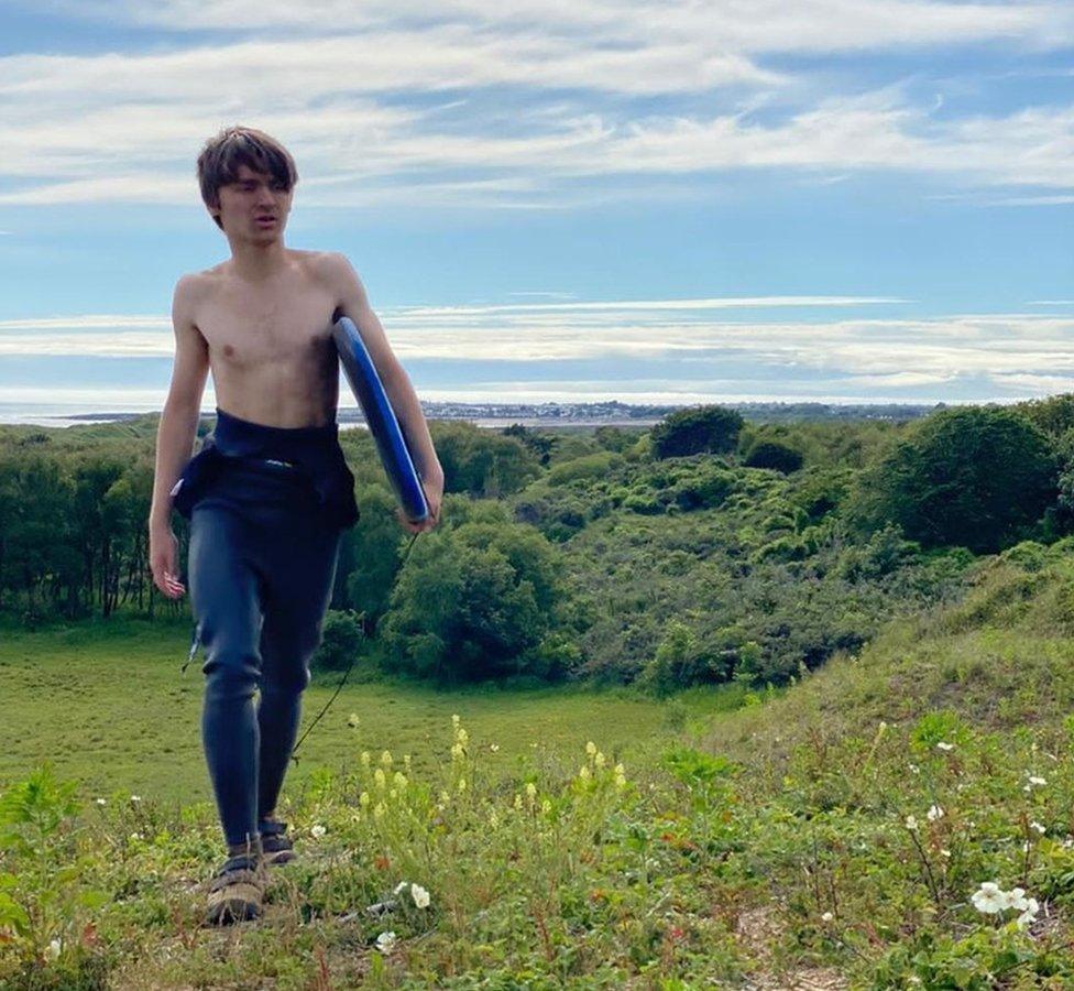 Jack Cavanagh walking with bodyboard