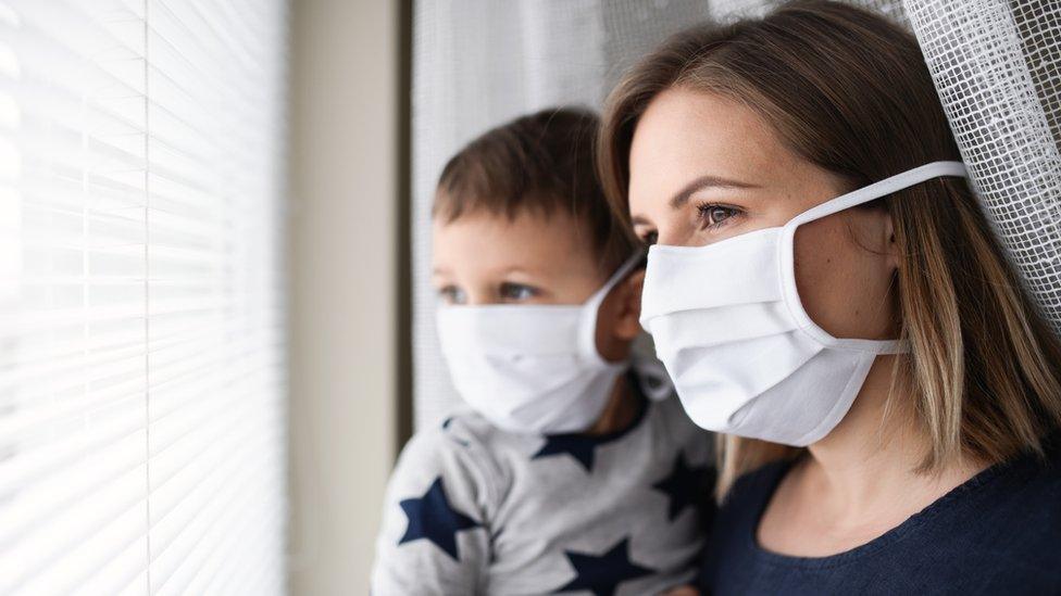 Parent with child in masks