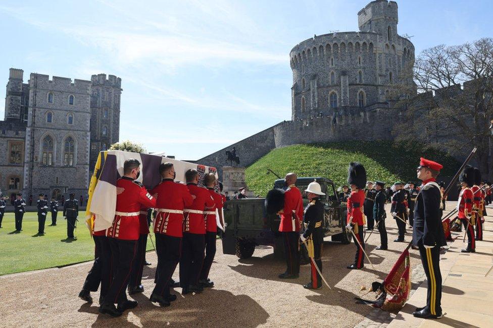 The Duke of Edinburgh's coffin, covered with His Royal Highness's Personal Standard is carried to the purpose built Land Rover during the funeral of Prince Philip, Duke of Edinburgh at Windsor Castle on April 17, 2021 in Windsor, England.