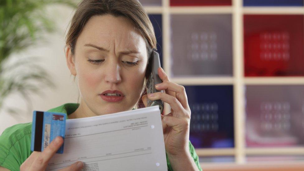 Woman looking at bills