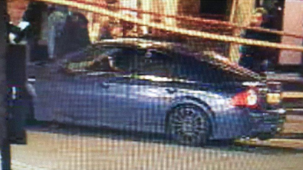 A CCTV still of a blue Ford Mondeo