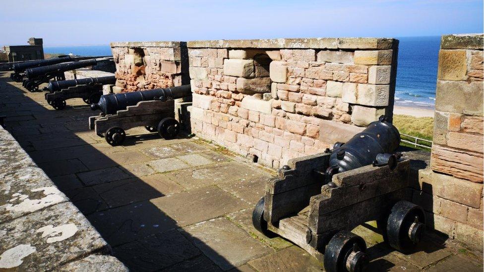 Cannons on the castle battlements overlooking the beach