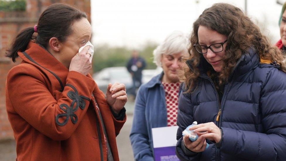 Rhiannon Davies (left) and Kayleigh Griffiths (right) react after report's publication