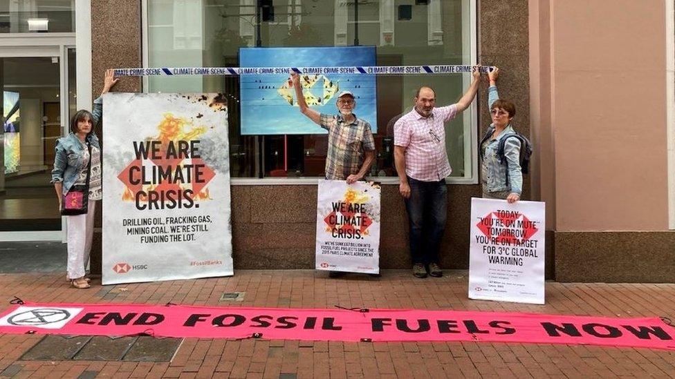 Extinction Rebellion protestors stand outside HSBC bank