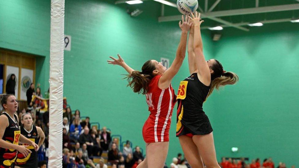 Netball players jumping for the ball