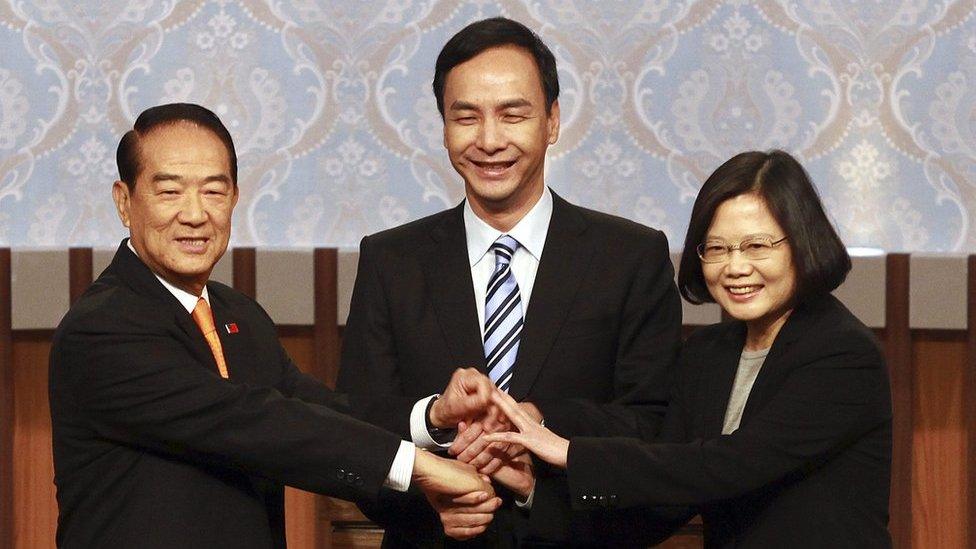 Taiwan's 2016 presidential election candidates with (L-R) People First Party's James Soong, KMT or Nationalist Party's Eric Chu, and Democratic Progressive Party's, DPP, Tsai Ing-wen, shaking hands as they pose for a group photo at the start of their first televised policy debate in Taipei, Taiwan, 27 December 2015.