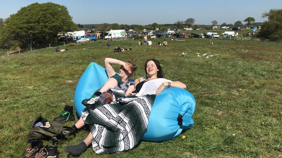 Revellers at the rave near Corfe Castle relaxing in the sunshine