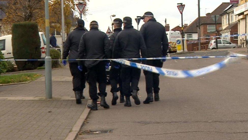 Police at the cordoned-off scene